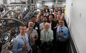 Team members celebrating the first beam through the FETS RFQ