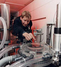 Adjustments being made on an experiment to study the adsorption of pro