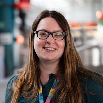 A woman with long hair and glasses