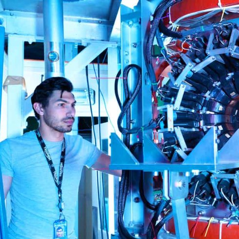 Instrument scientist, Adam Berlie, in front of the Argus muon instrument