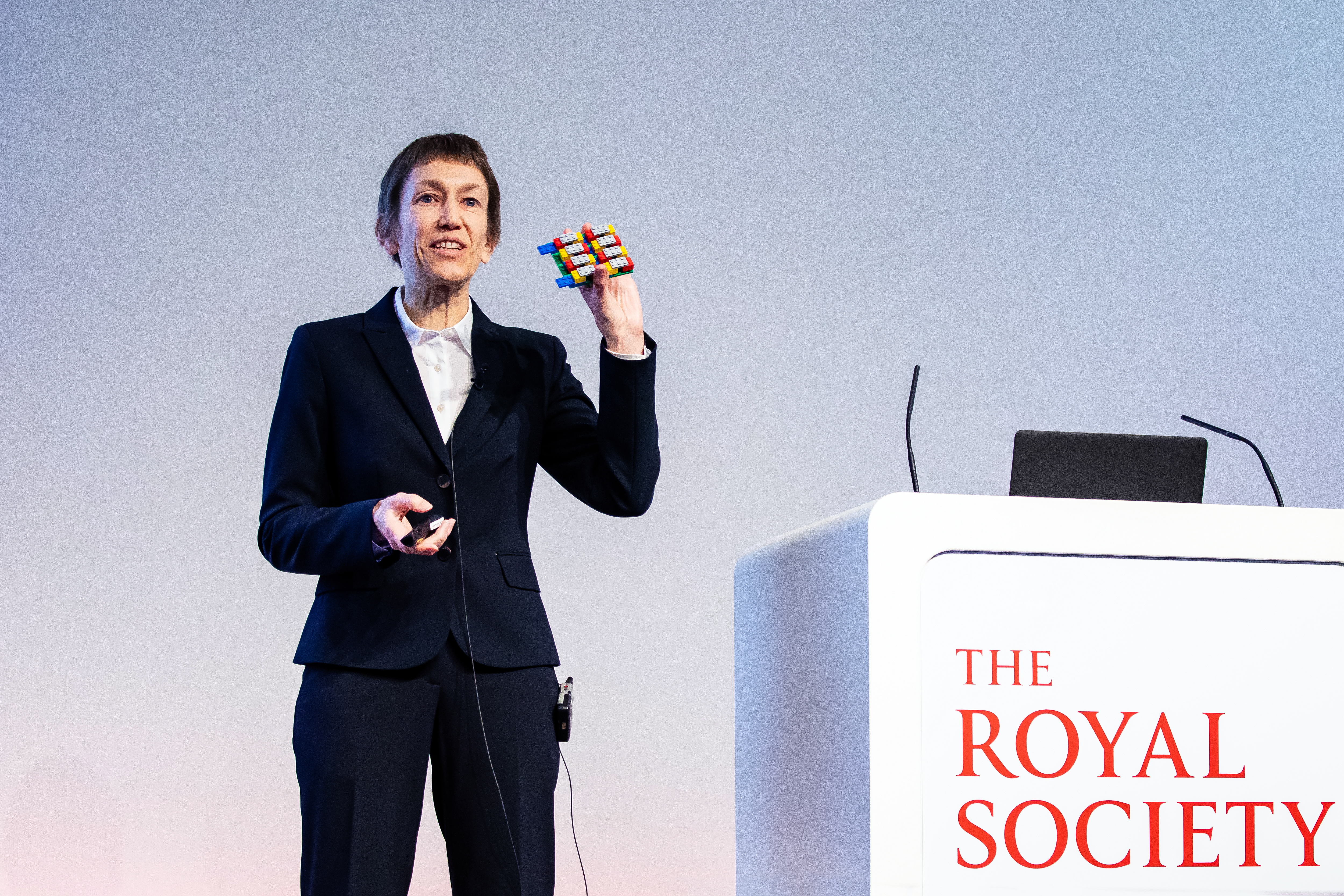 Jacqui holding a lego model of a thermoelectric material