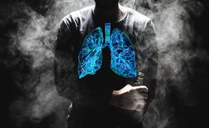 A man vaping, with his lungs highlighted in blue