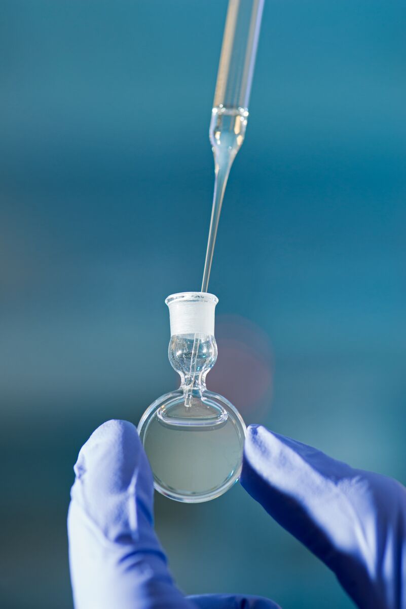Liquid being pipetted into a circular vial