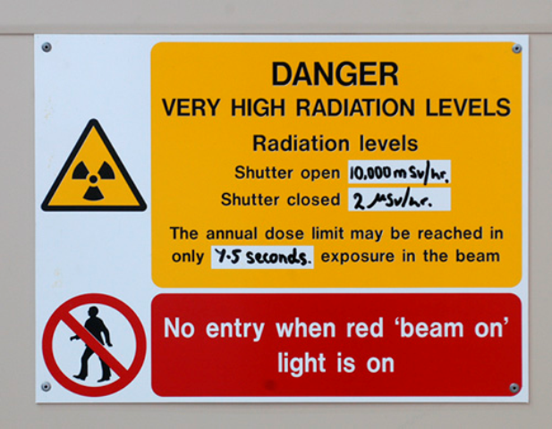 A sign with a yellow background saying "Danger. Very high radiation levels."