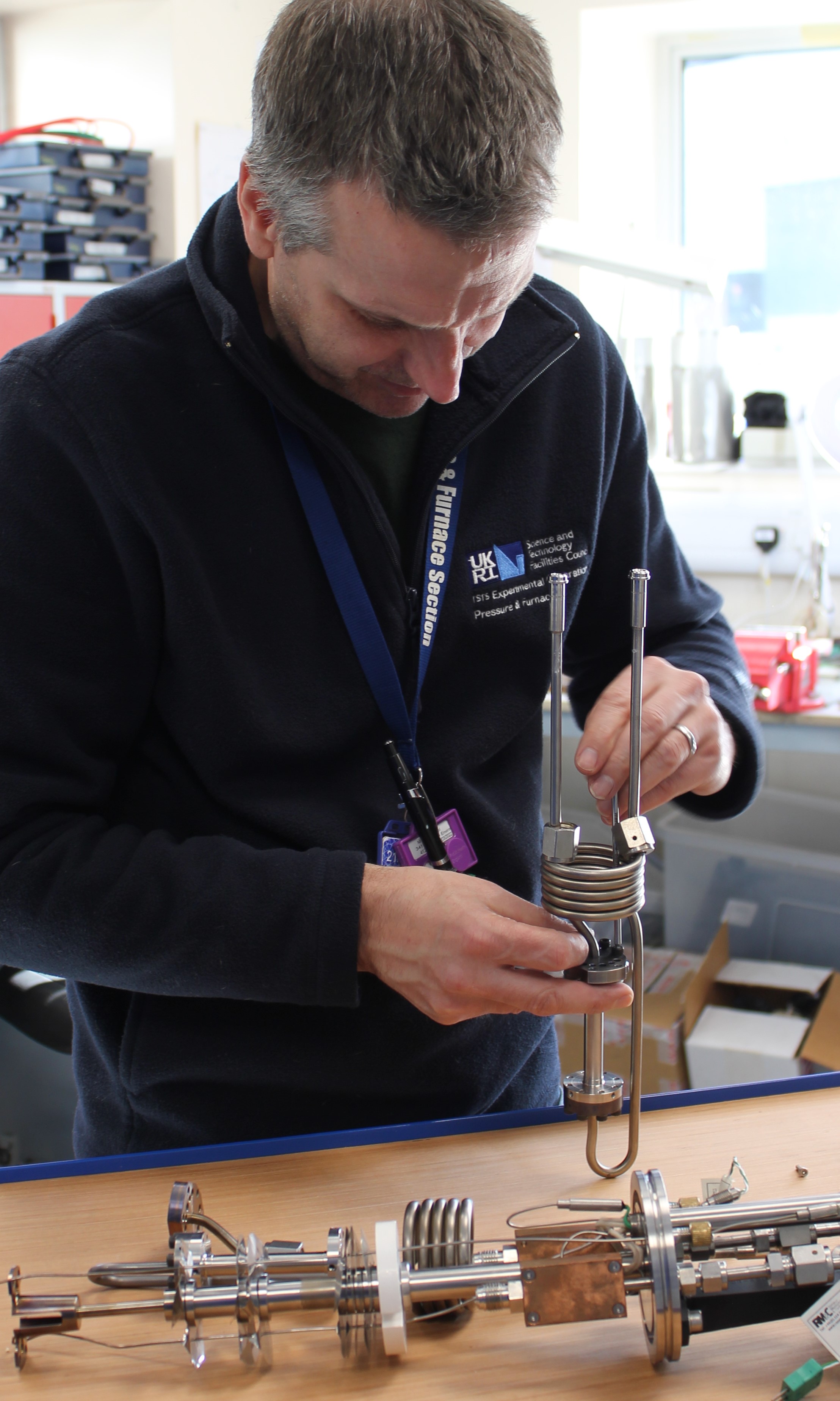 A member of the pressure and furnace section assembling a sample stick for pressure testing