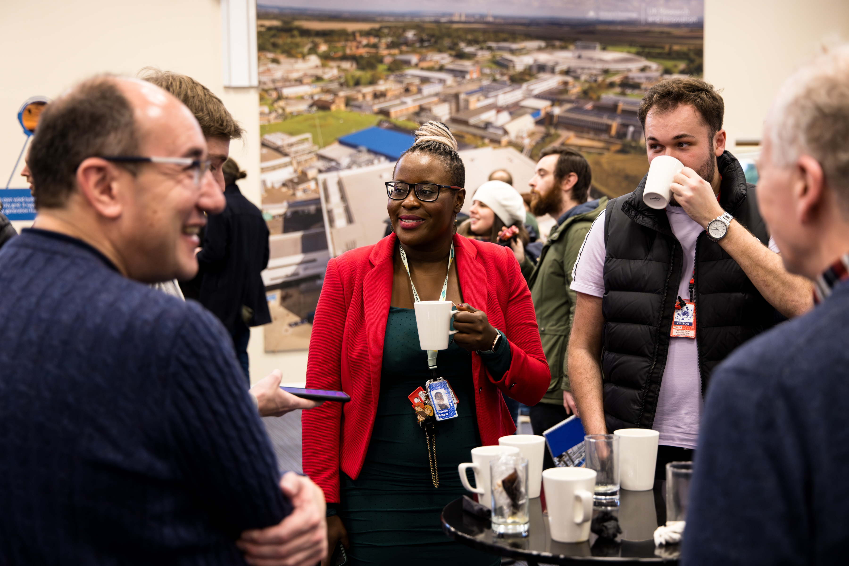 23EC9383 Isis staff meeting - staff chatting diversity.jpg