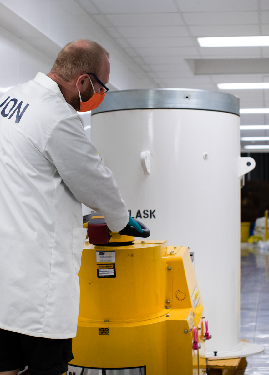 Jon using a trolley to move the target flask