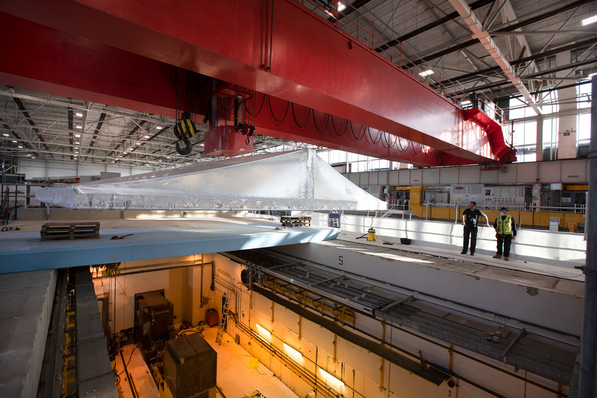 Temporary roof being craned into place over the empty TSA